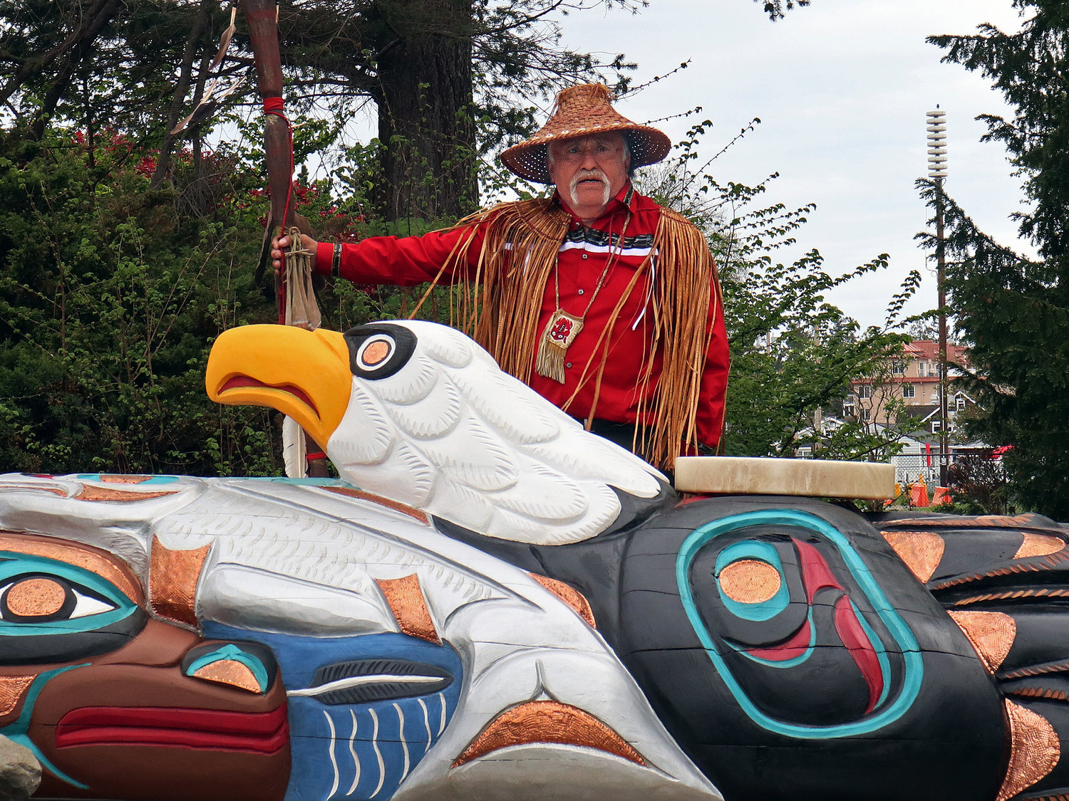 Jewell James presents the totem pole at the site of the future Birch Bay Vogt Community Library on May 8.