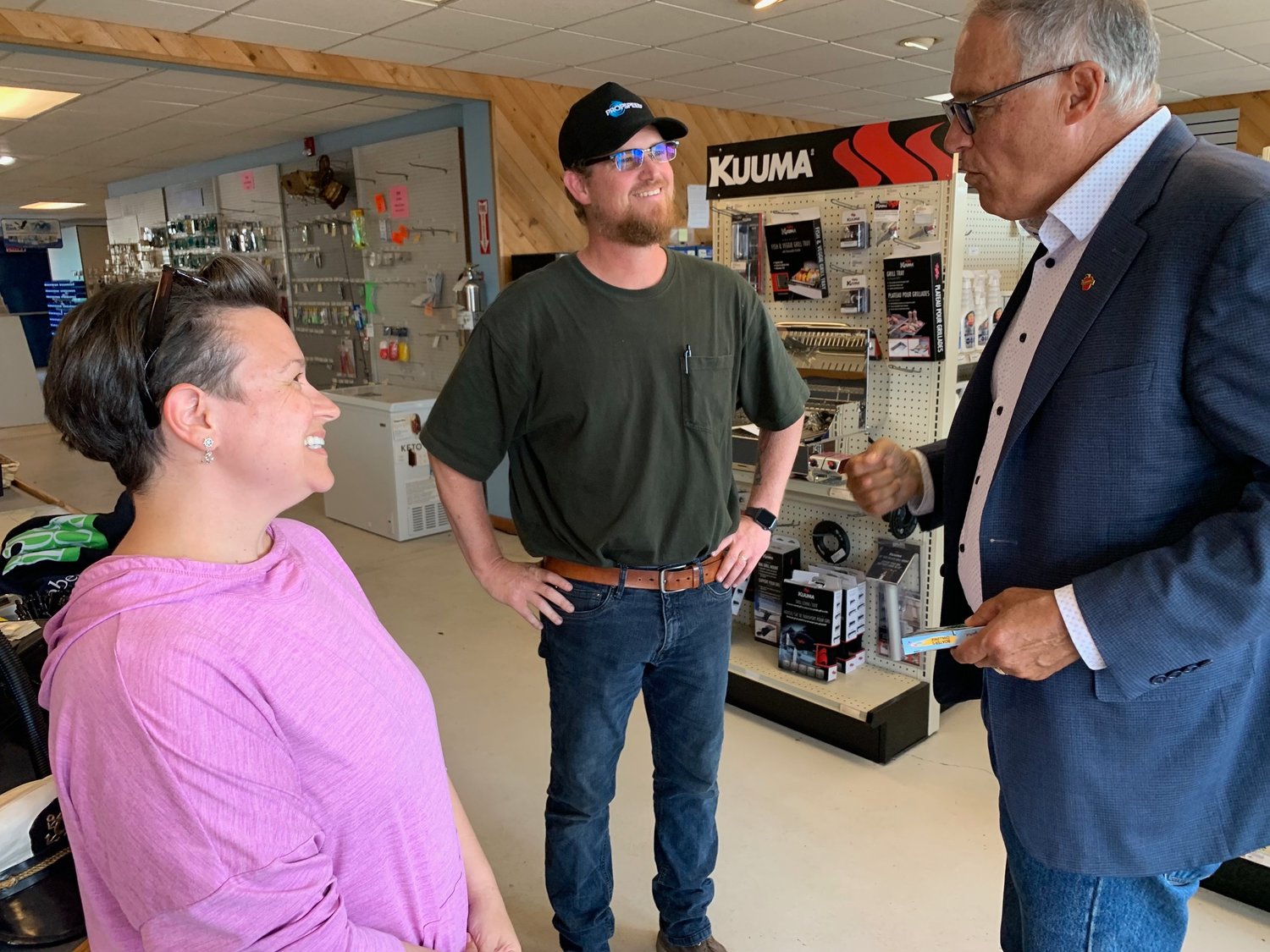Westwind Marine owners Jessica and Bryson Basore talk with governor Jay Inslee on July 9.