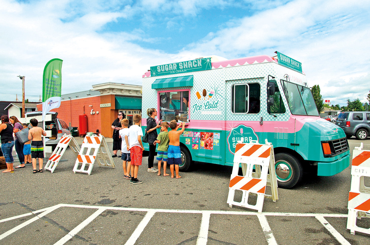 Families visit the Sugar Shack ice cream truck for frozen treats during Splash Days.