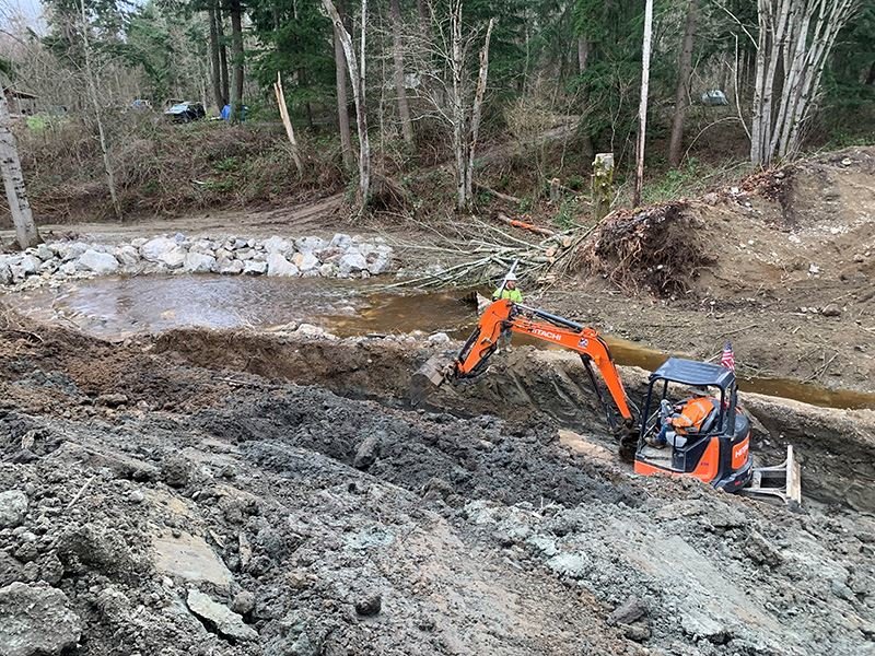 Crews create a temporary stream diversion at Birch Bay-Lynden Road to allow pipe to eventually be placed.