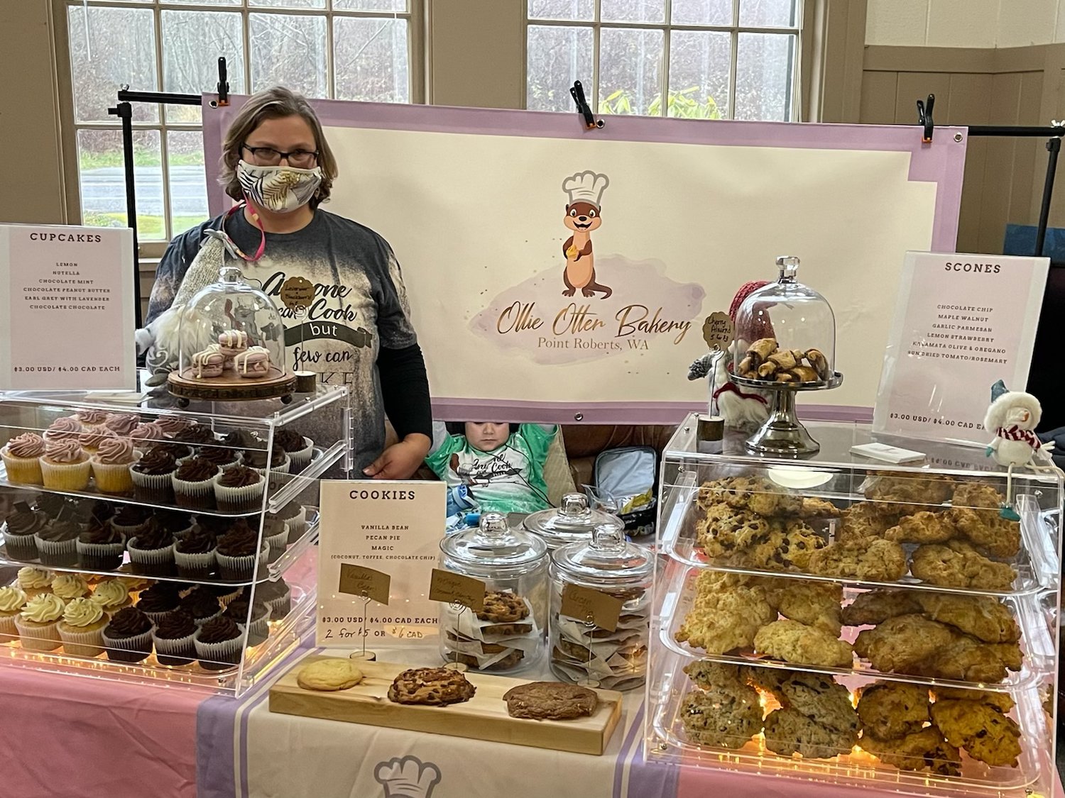 s Kathleen Friedman attending her Ollie Otter Bakery booth at Your Local Small Market.