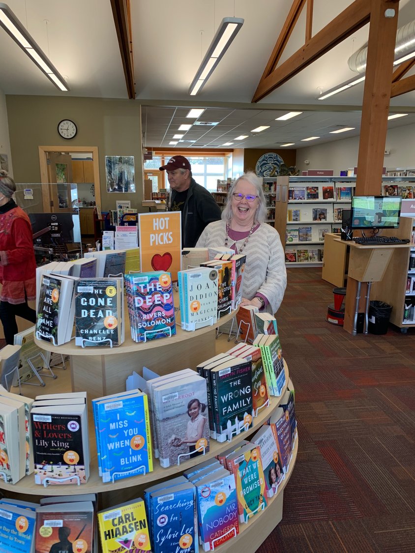 Kris Lomedico, branch manager at the Point Roberts Library with a selection of Hot Picks.