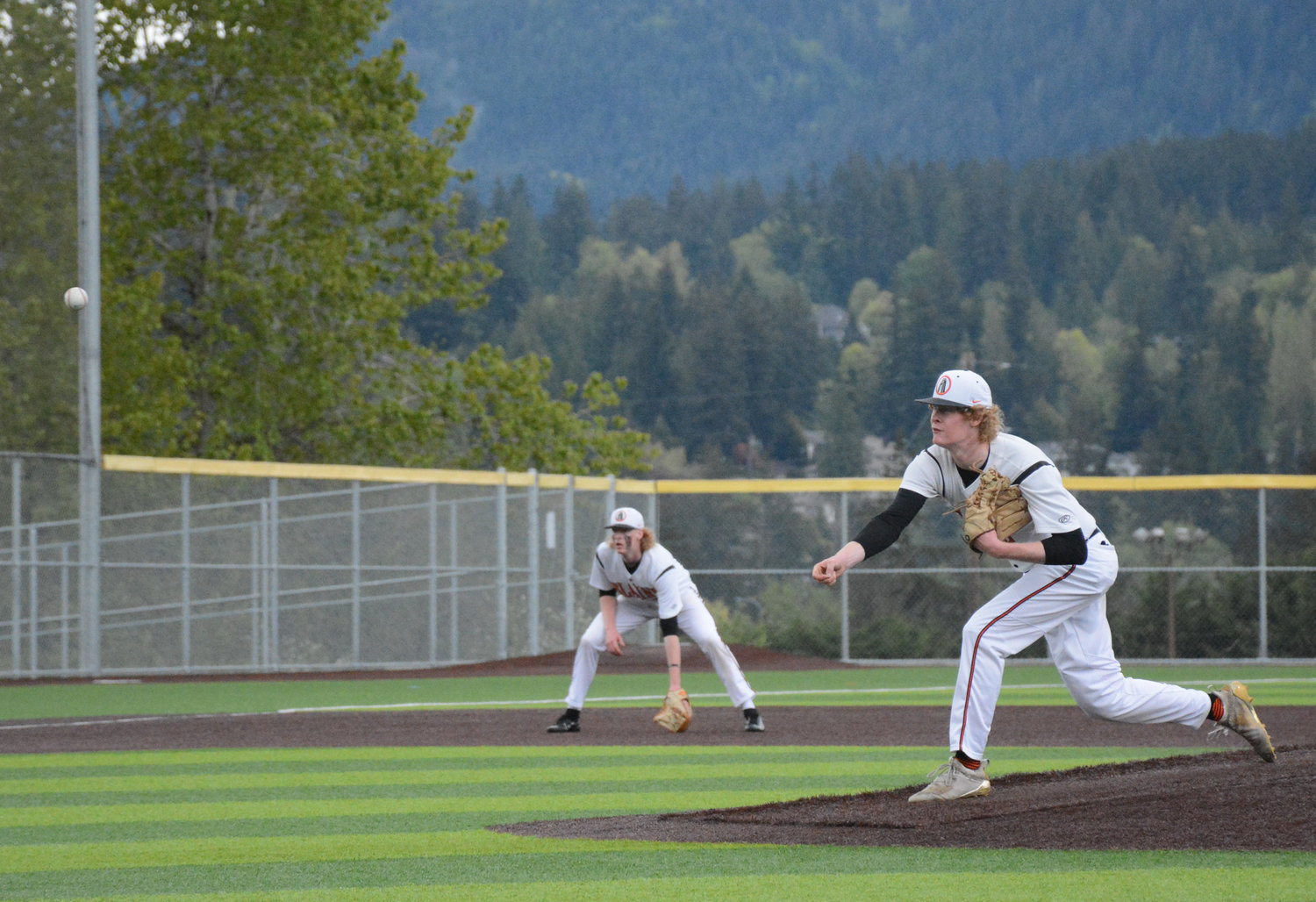 Anden Holley throws a pitch, r., as twin brother Aiden Holley stands ready at third base in Blaine’s 6-4 loss to Overlake-Bear Creek May 14 at Sehome High School.