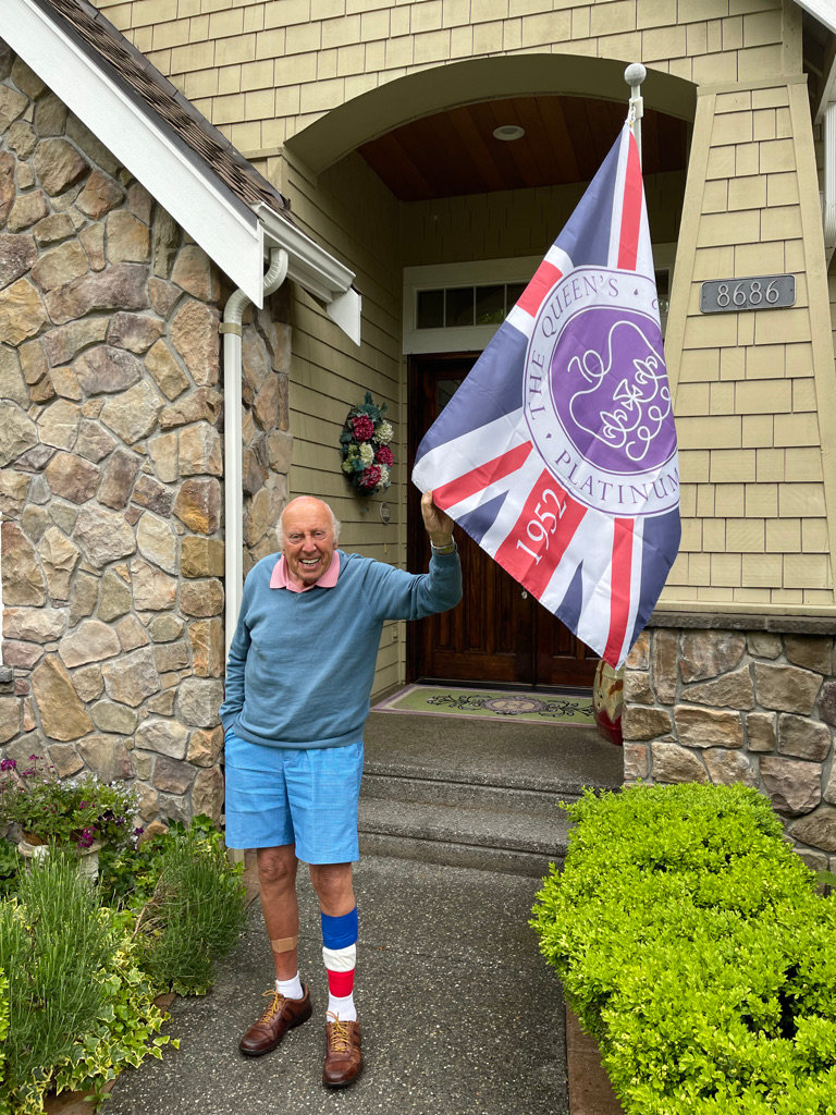 Trevor Hoskins, 88, at his Semiahmoo home with a flag celebrating Queen Elizabeth II’s 70th jubilee anniversary. Hoskins, who is now a U.S. citizen, was part of a Royal Air Force (RAF) squadron that marched at the queen’s coronation in 1953, immediately following the death of her father. Hoskins said he was very fortunate, because his RAF squadron was due to leave for Korea two weeks previously, and then the armistice was signed. However, he did go to the demilitarized zone in Korea, 42 years later, as a passenger in the forward gun position of a U.S. Black Hawk helicopter. This was as part of a delegation to attend a southeast U.S. conference with Japan and Korea in 1995, during the time he was senior vice president of Bridgestone Corporation. Although it was an honor to be selected for the coronation, Hoskins said the conference was a better experience because during the coronation they marched for miles, sometimes in pouring rain, through the streets of London.