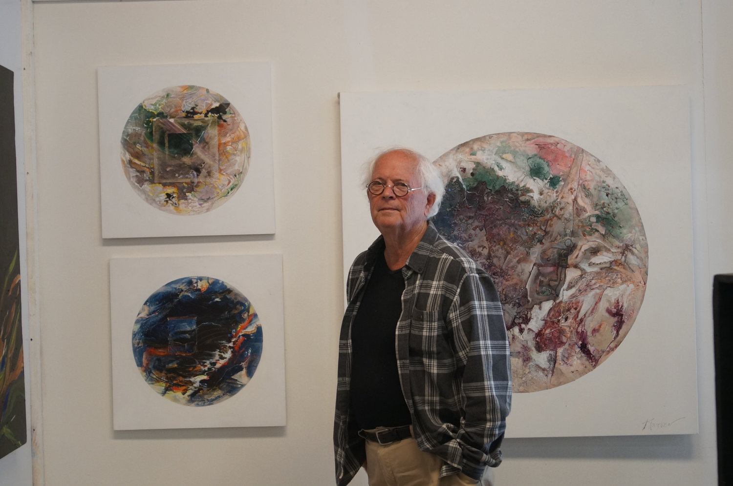Joseph Kinnebrew stands in front of three abstract pieces from his “Celestina Novicum” series in his Birch Bay art studio on June 17.