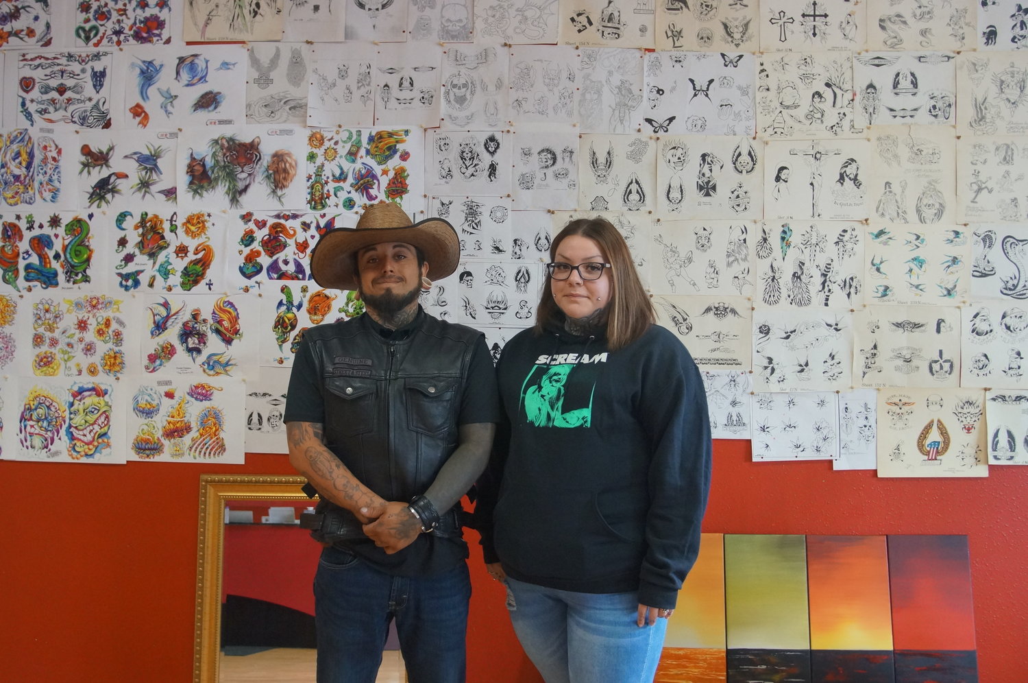 From l.; Owners Dev Saucedo and Brittany Saucedo stand in their new tattoo shop, Traditional Ink.