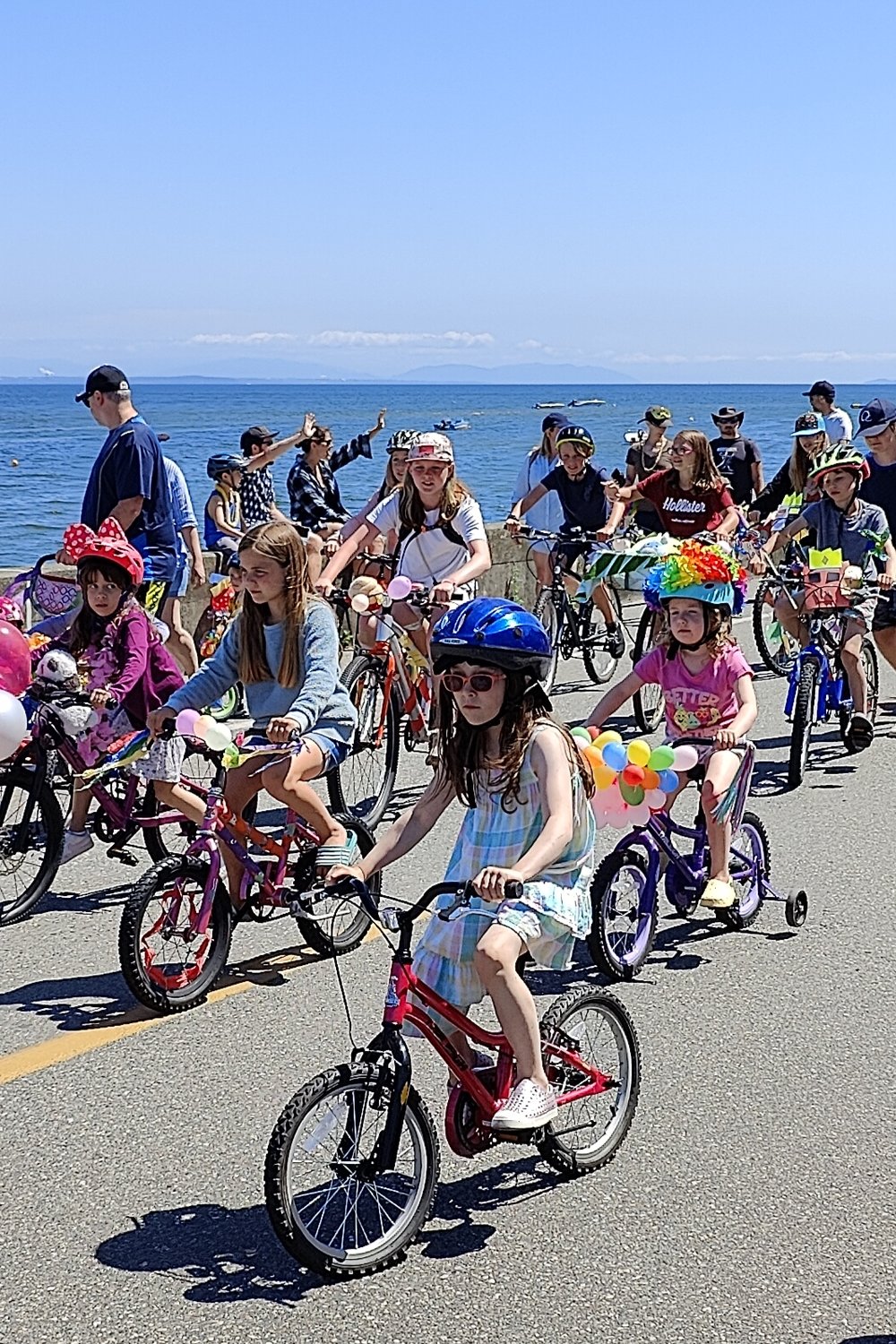July’s hot weather got everyone out to the beach. The Maple Beach Bike Parade brought out around 50 young cyclists on July 23. Sweet Water Ice Cream truck was on hand to help everyone cool off. On July 1 the Delta Police Pipe Band performed at the border separating Centennial Beach, Tsawwassen and Maple Beach, Point Roberts.