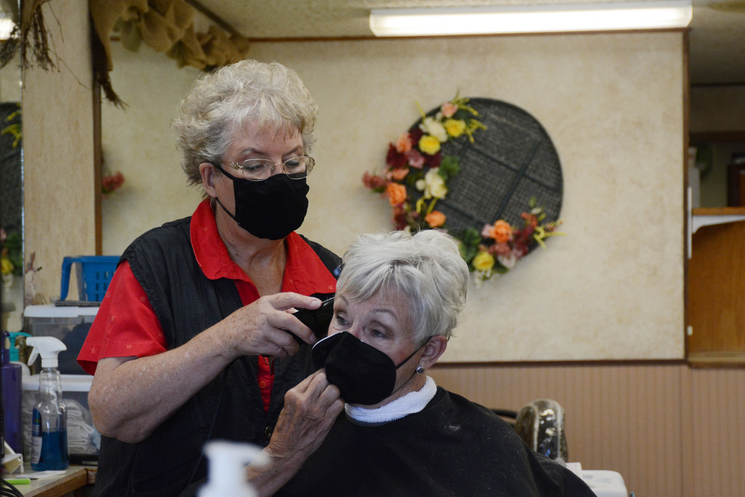Judy Dunster cutting a client’s hair at Bayside Beauty Salon on August 5.