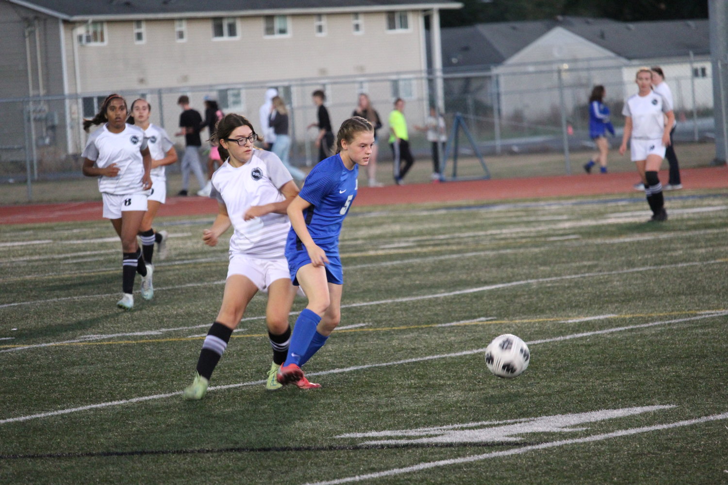 Abby Marquez defends her mark in Blaine High School girls soccer opening game of the season.