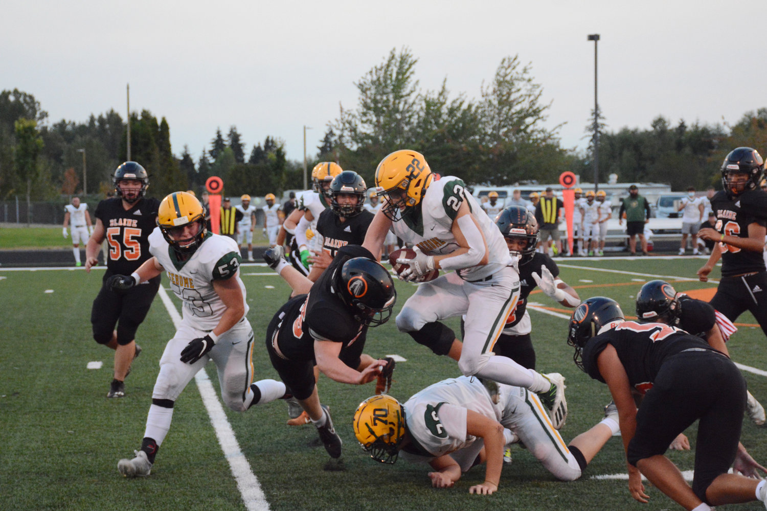 The Borderites throw themselves at the rushing Mariner offense at the Blaine High School stadium on September 9.