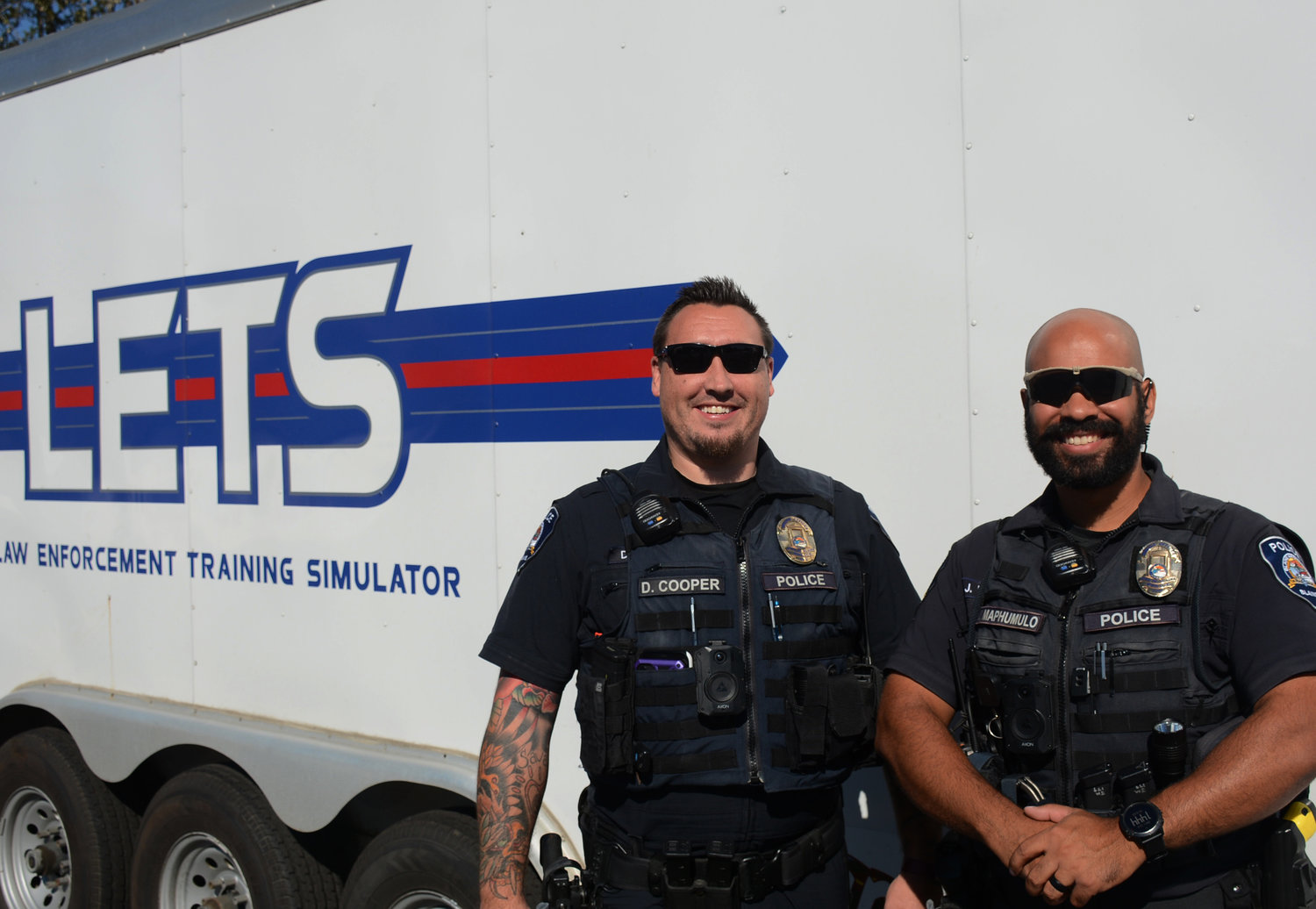 Blaine Police Department officers Devin Cooper, l., and Jordan Maphumulo stand outside of the Clear Risk Solutions trailer after virtual use-of-force training.