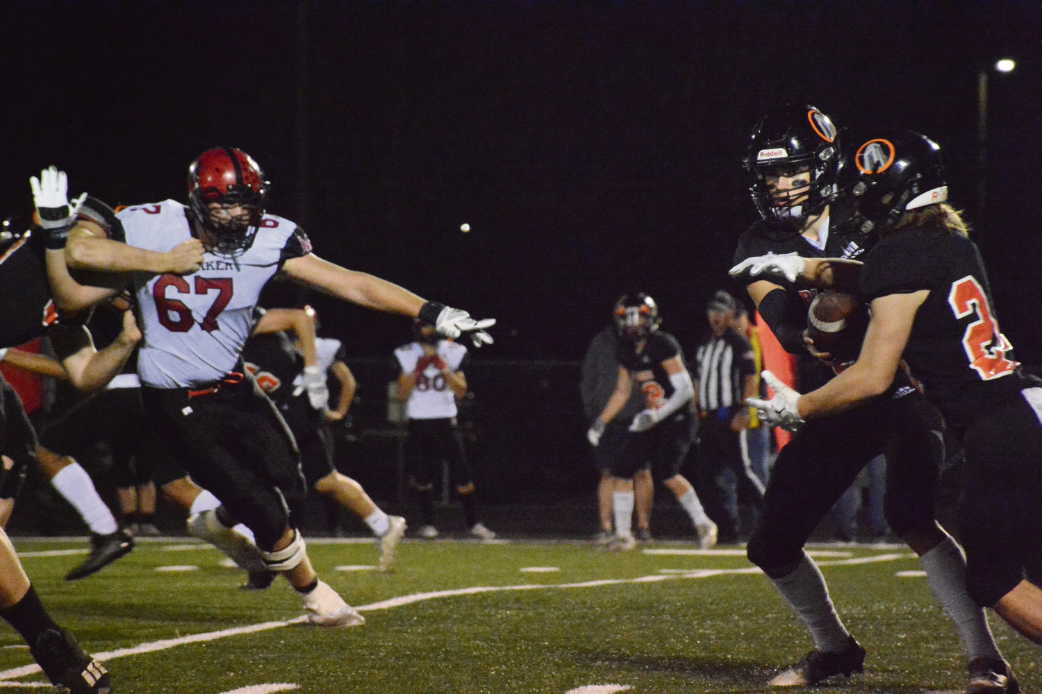 Senior quarterback Kael Evinger hands the ball off to sophomore Colby Shipp in Blaine High School’s homecoming game on September 30. Blaine’s football team took on Mount Baker High School during the hard-fought game at the Borderite stadium.
