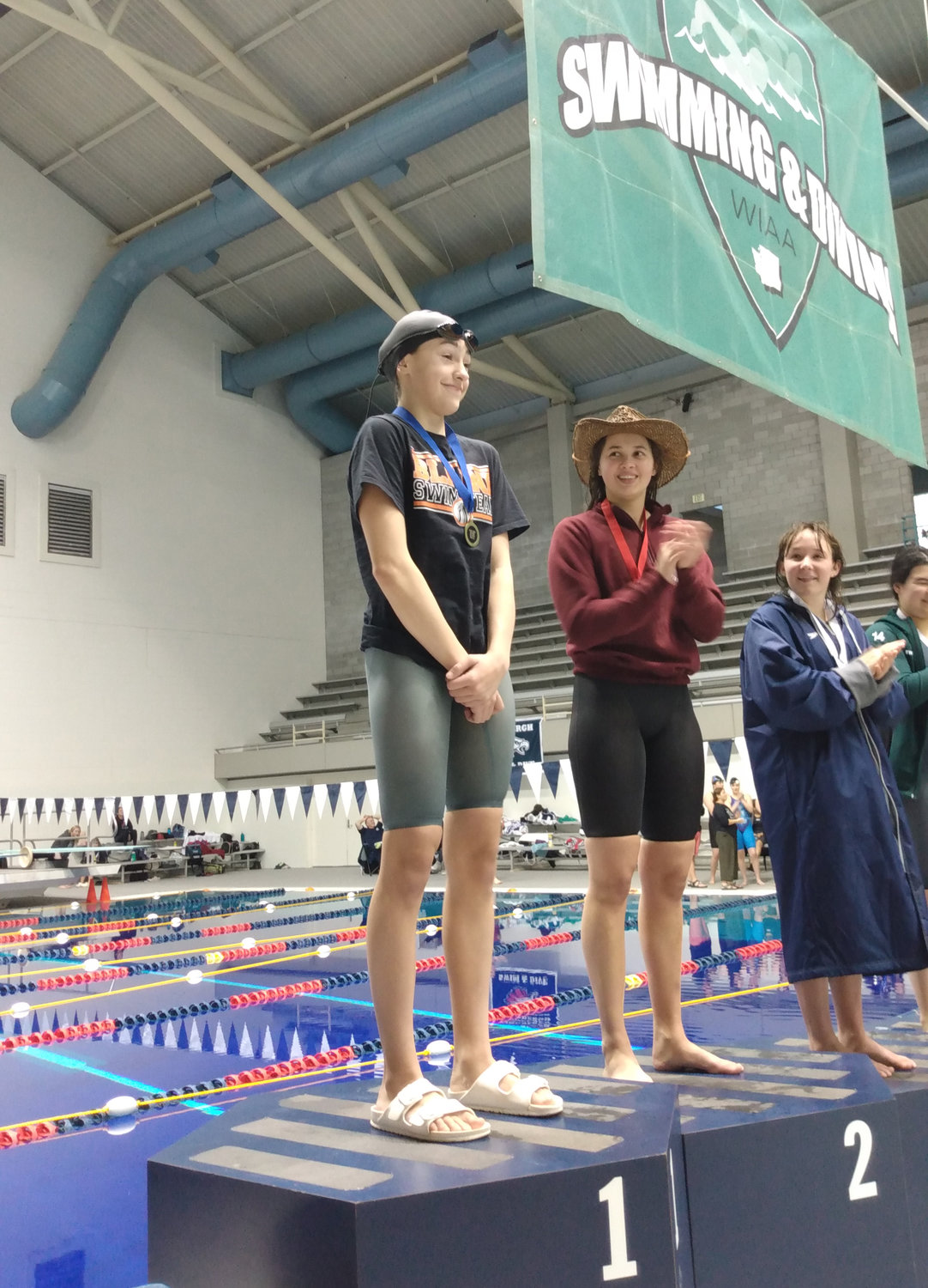 Blaine freshman Hailey Ferrell on the top step of the podium after winning the girls 2A 500 freestyle state championship November 12 at Weyerhaeuser King County Aquatics Center in Federal Way.