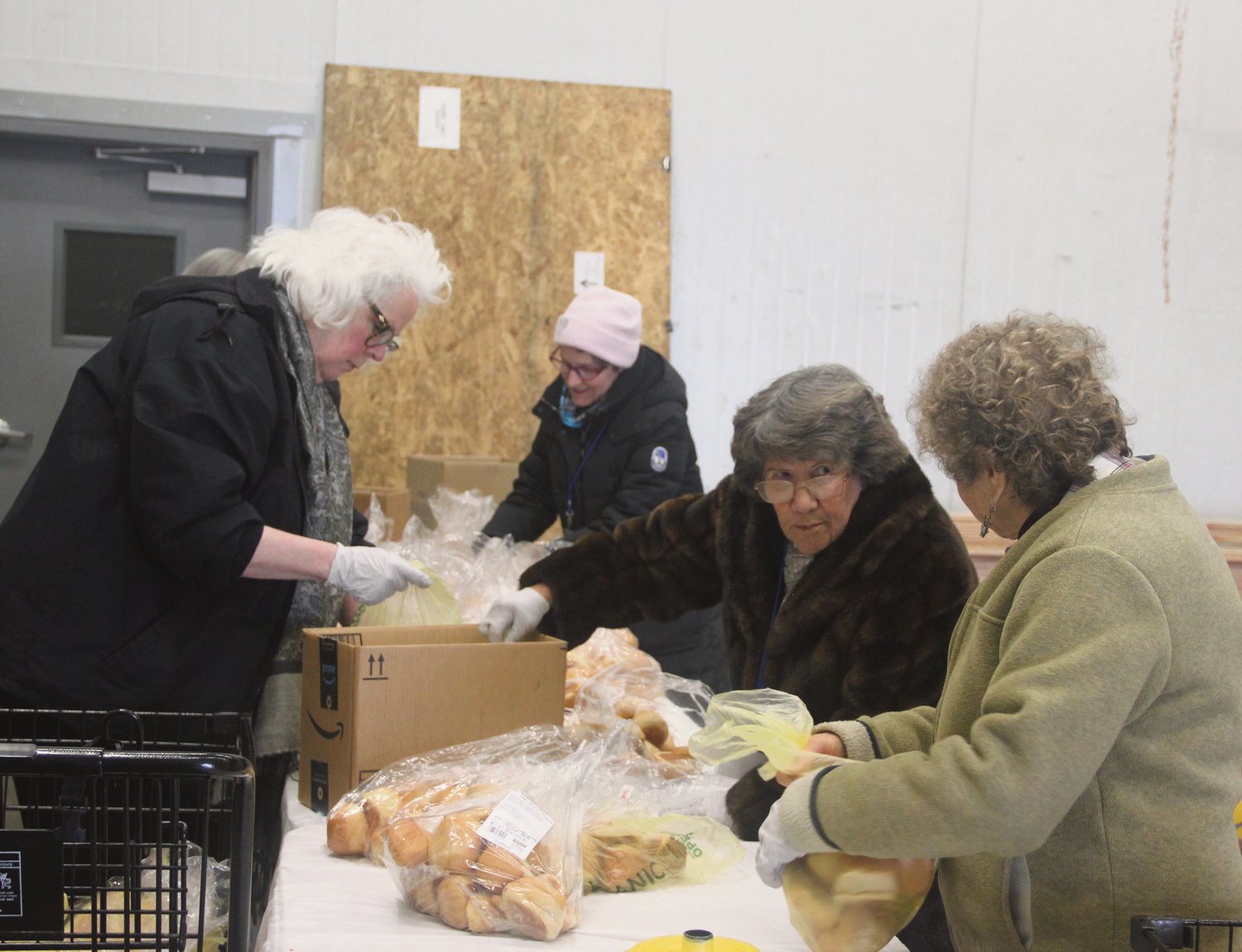 Community Assistance Program (CAP) volunteers sort bread rolls for the nonprofit’s Thanksgiving baskets on November 21. CAP planned to distribute over 200 baskets filled with traditional holiday fixings such as ham, cranberry sauce, stuffing mix and canned green beans behind Cost Cutter. From l.; Evelyne Hendricks, Barb VanSwearingen, Mary Ellen Rathe and Jackie Braverman.