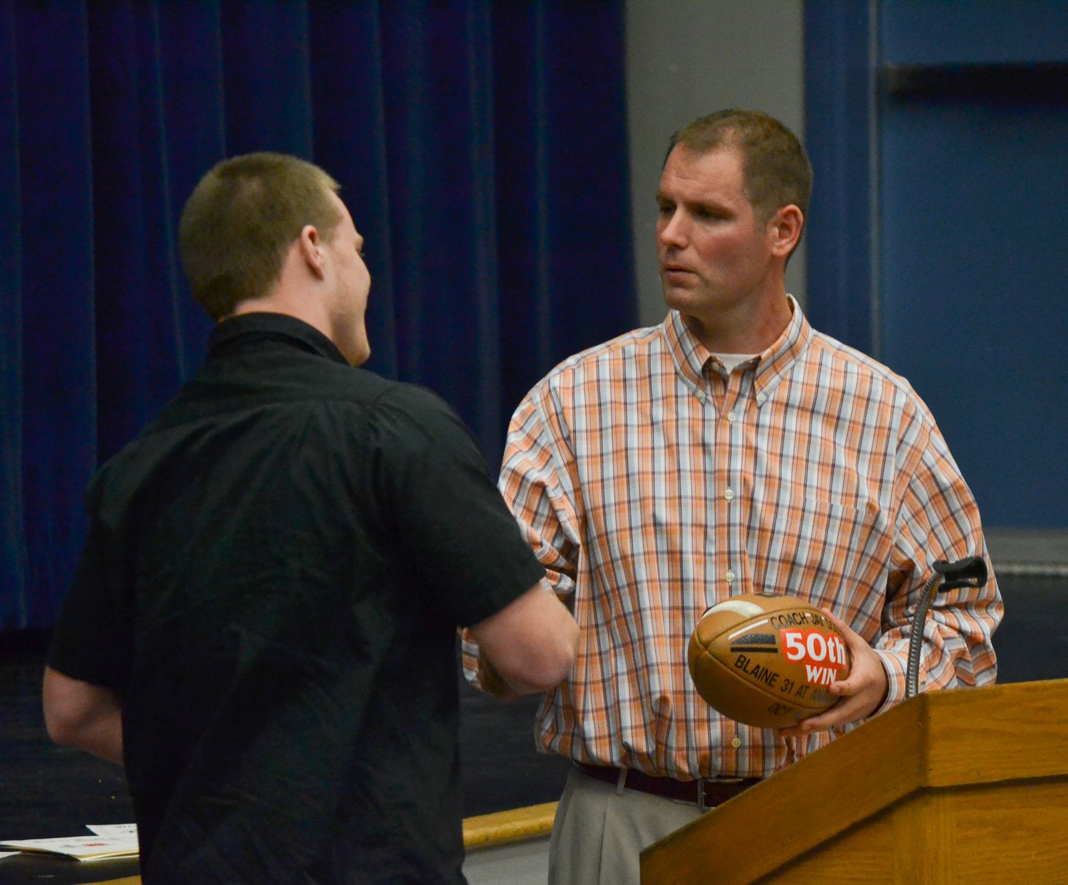 Jay Dodd is presented with the football from his 50th winning game as Blaine’s football coach in November 2014.