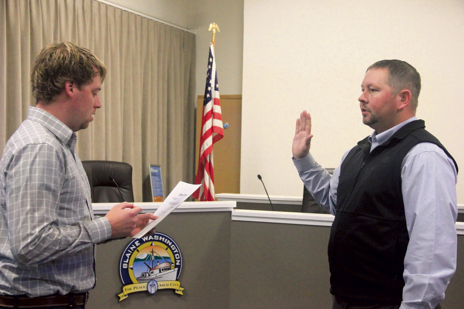 Deputy city manager Sam Crawford, l., swears in Michael Harmon as Blaine city manager in council chambers before he started his first day on the job January 17. Harmon previously worked as a chief operating officer of an electric utility provider in Wyoming and former city administrator in Spearfish, South Dakota.