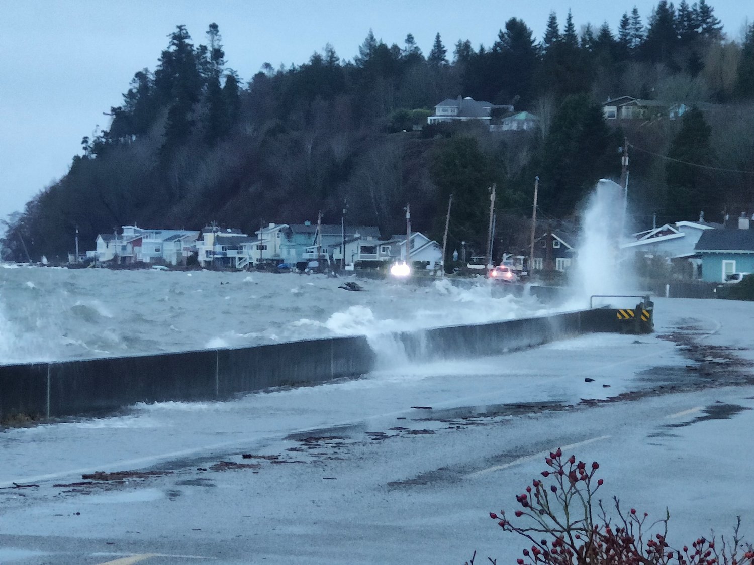 Waves, water and debris topping the Bayview Drive seawall.