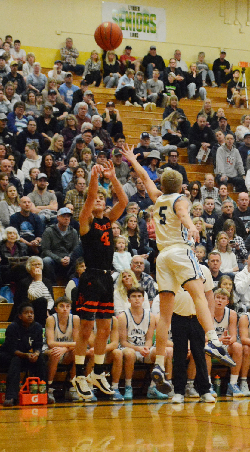 Noah Tavis shoots a 3-pointer in Blaine’s district championship loss to Lynden Christian February 11 at Lynden High School. If both Whatcom teams continue to win, they could meet again in the state championship.