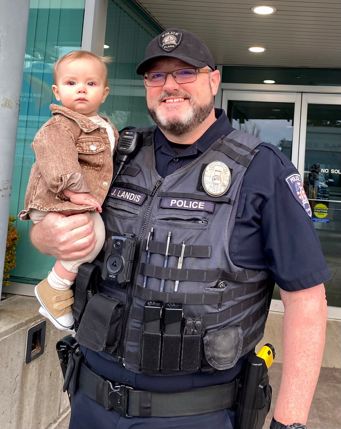 Blaine Police Department officer Jon Landis with his grandson Arlo in 2022.