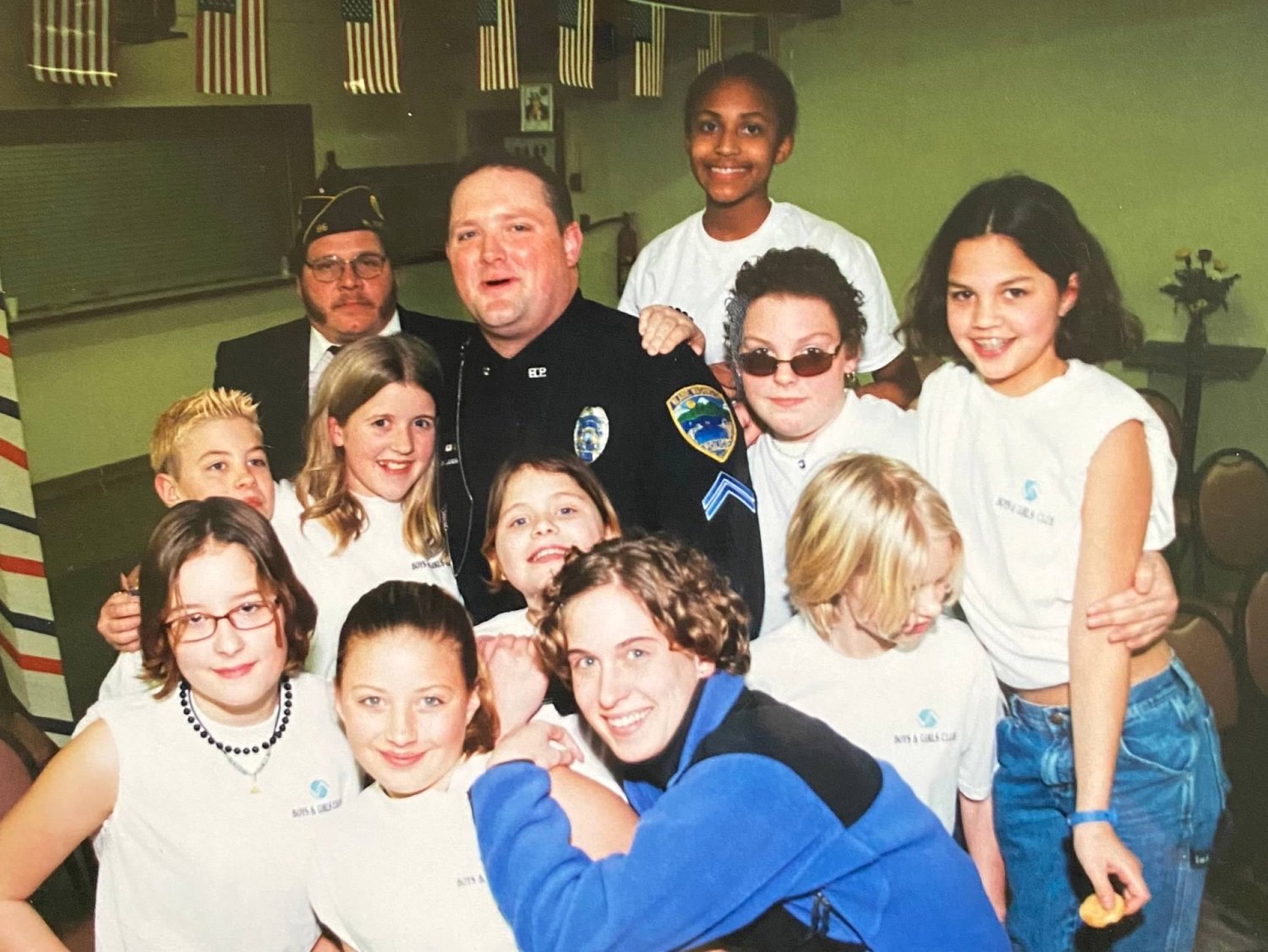 Officer of the Year Jon Landis, c., with Boys and Girls Club kids in 2002.