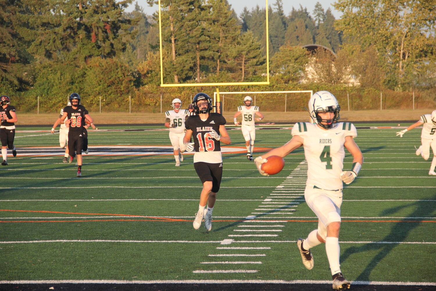 Port Angeles junior wide receiver Blake Sohlberg runs past Blaine senior defensive back Jesse Deming on a long touchdown pass in the first quarter of Port Angeles’ 44-21 win over Blaine on September 1.