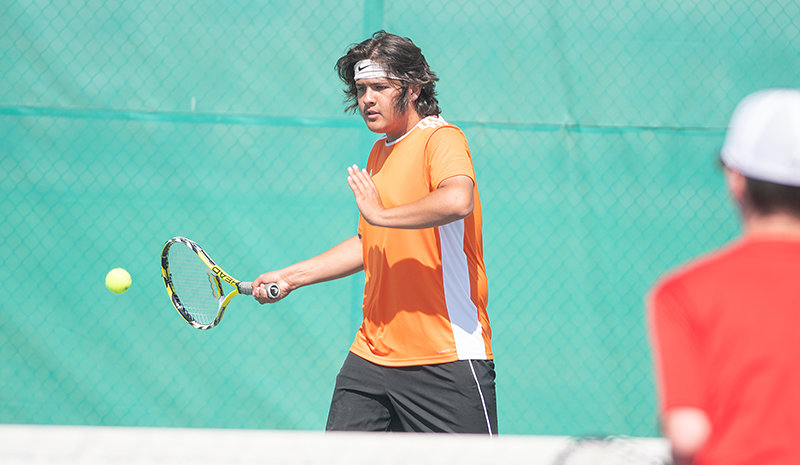PHS tennis player Kolt Flores returns a serve in Powell&rsquo;s match against Rawlins earlier this season. He and No. 1 doubles partner Logan Brown went 1-1 against Natrona County and Kelly Walsh last weekend.