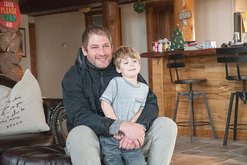 Chris Cooley poses for a picture with his 3-year-old son, Bodi. The former Washington Redskins tight end moved from Powell when he was 10 and now resides west of town with his family.