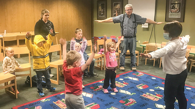 Renee Hanlin (at right), the children&rsquo;s librarian at the Powell Library, leads a group of children and their family members during a Story Time session on Oct. 26. It was one of roughly 1,000 images captured around the state on Wyoming Libraries Snapshot Day.