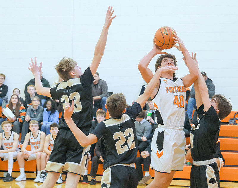 PHS freshman Zane Graft finishes while surrounded by three Buffalo defenders in the JV team&rsquo;s last home game of the season in February.