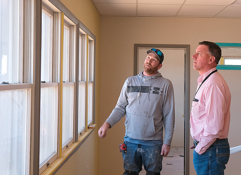 Tyler Phillips (at left) disucsses the renovation of the Park County School District 1 cottage with Support Services Coordinator Rob McCray on Wednesday. Issues with the building that were discovered after construction began have led to delays.