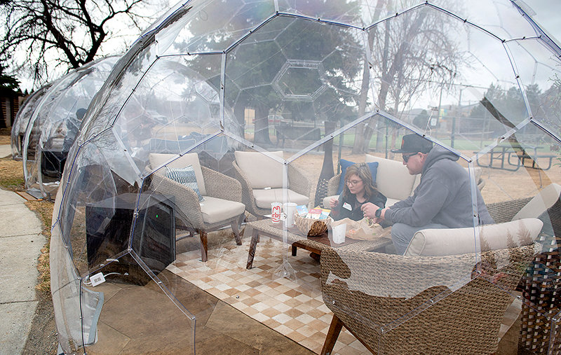 Chrystal and Calvin Alpers share lunch in Cody as a cold wind blows and flakes of snow fall at the new domes built with funds from the federal government&rsquo;s Coronavirus Aid, Relief and Economic Security (CARES) Act. The Park County Travel Council purchased the domes, which can withstand winds of up to 115 mph.