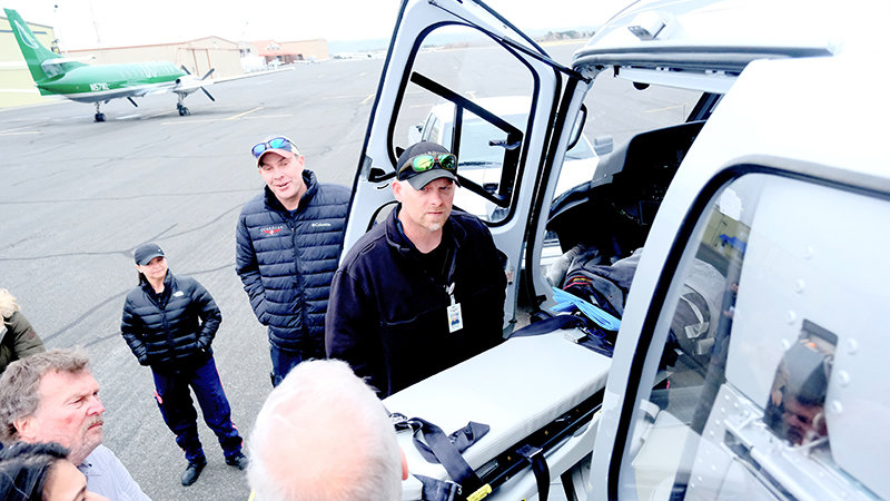 Guardian Flight Base Manager Joshua Campbell, front, and Lead Pilot Kevin Winters show off some features of the company&rsquo;s H125 helicopter, which is based at Yellowstone Regional Airport in Cody, to legislators during a membership signing ceremony last week.