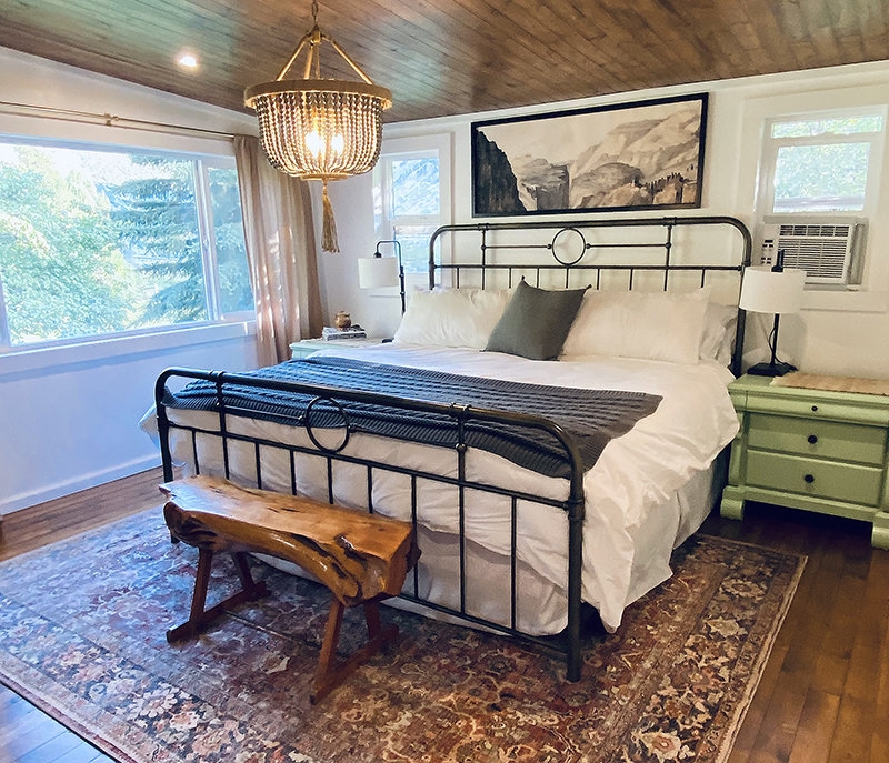 One of the bedrooms in the house has recently been remodeled with a new ceiling and refinished original hardwood floors. Finishing and painting as well as decorations were done by Erin Curtis who holds a degree in interior design. The support beam in the upper left of the photo is an early example of a suspension system widely used at the Seattle-Tacoma International Airport. This system uses a smaller beam along the ceiling that&rsquo;s bolstered by a steel wire.