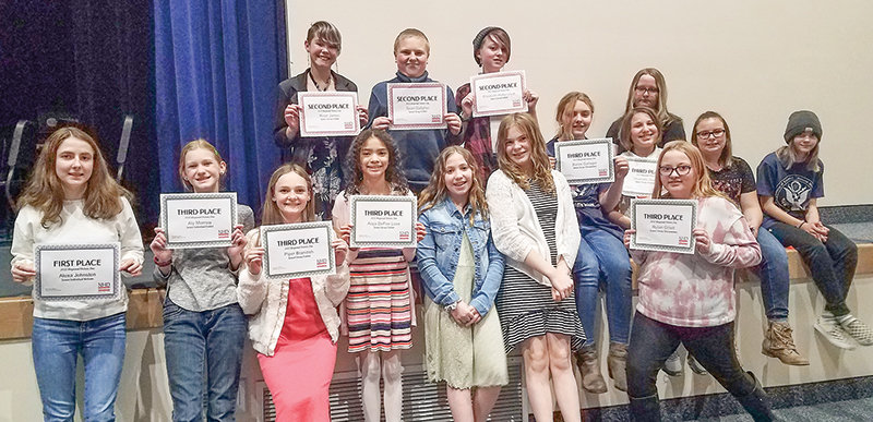 Powell Middle School students hold up their awards in Greybull on March 9 following a successful regional History Day competition. Back row, from left; River James, Sean Gallagher, Elizabeth Halberstadt and Vivienne Dodds, front row: Alexa Johnston, Aly Morrow, Piper Brandish, Alaja DeFoe Love, Claire Hultgren, Bailee Kraft, Bailee Gallagher, Charlotte Seddon, Rylan Gillett, Tempie Day and Lily Watts.