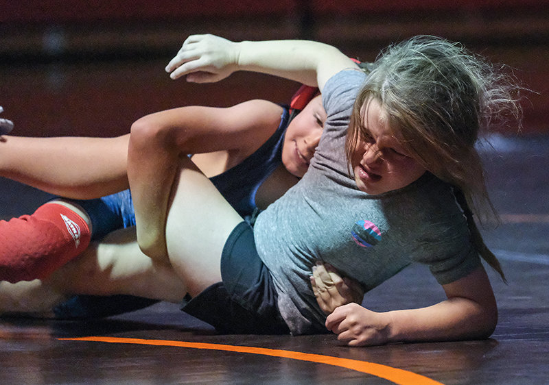 Kamdyn McNeil uses all of her strength to keep herself up as she battled with Bristol Pettet during the final duals at the Bighorn Basin Wrestling Camp on Wednesday.