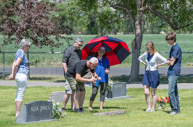 (Left to right) Brenda and Don Reynolds and Jeremy and Kathy Reynolds and their two children Trinity and Ezekial honor a family member, Albert Johnson, at his gravesite at Crown Hill Cemetery July 2. The family secured a replica medal for his headstone to commemorate his Carnegie Hero Medal awarded posthumously in 1910.