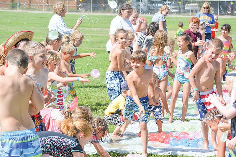 Powell&rsquo;s local youth enjoy the water balloon war which is supplied by over 20,000 balloons, as part of the annual Last Splash of Summer hosted by Powell Kids&rsquo; Day. This year&rsquo;s fundraiser will benefit OurKids and Backpack Blessings.