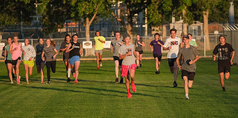 The Panther boys&rsquo; and girls&rsquo; cross country team does some striders to warm up for practice on Thursday, getting out early for a 6 a.m. start.