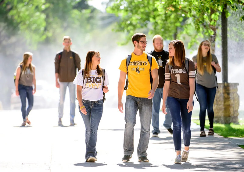 Students enjoy a warm August day on the University of Wyoming campus in Laramie. UW trustees are mulling a change in how student fees are charged, moving from per-credit billing to a flat rate.