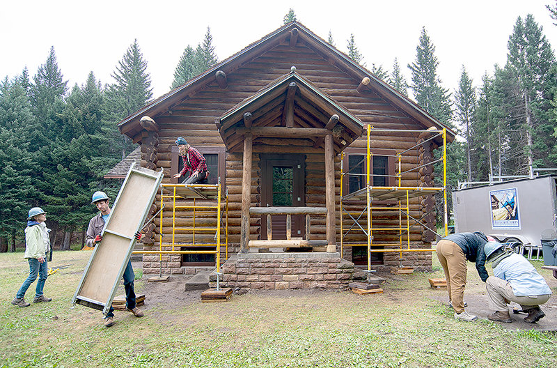 A crew of volunteers from HistoriCorps works on the old district ranger residence at the Crandall Ranger Station. The cabin was built more than 80 years ago and was in desperate need of updating as it now serves to house seasonal workers in the Shoshone National Forest. The project is being funded by the 2020 Great American Outdoors Act.