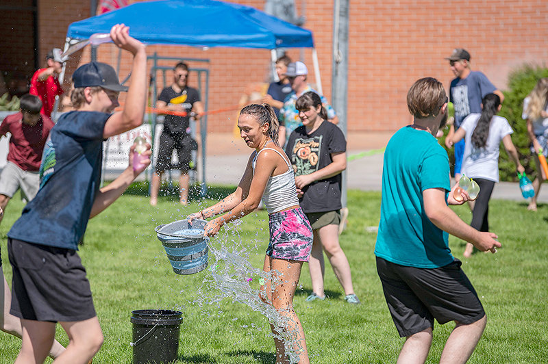 NWC student Carissa Fostervold gets wet along with other students during the Kick-Off Water Works event.