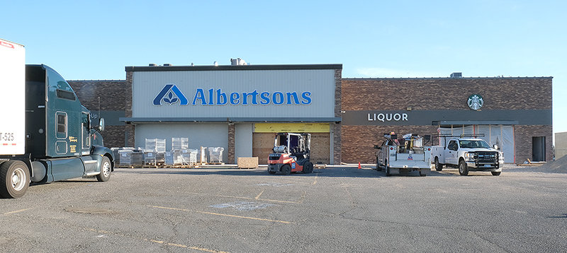 More equipment is delivered Tuesday on a truck driven up from Southern California as interior work continues on the new Albertsons on U.S. Highway 14A.