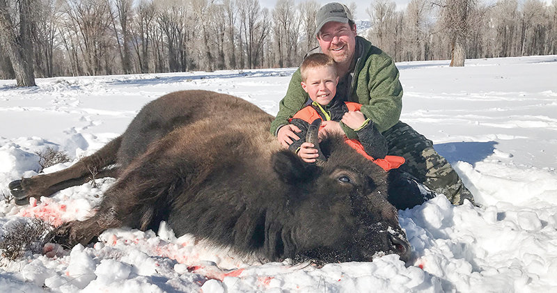 Ryan Muecke and his son Tucker get a photo with their cow bison that was nicknamed &lsquo;cowzilla&rsquo; by a local game warden. The family has introduced outdoor sports to their children and the family works together to harvest and process all their game.