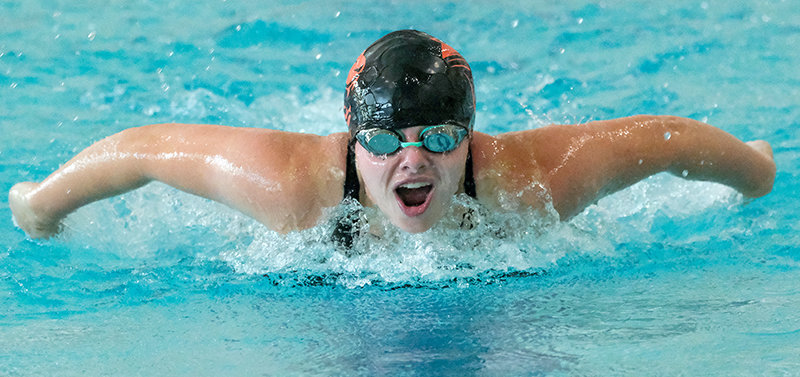 PHS junior Croix Tryon rises out of the water during the 100 fly on Friday in Cody.