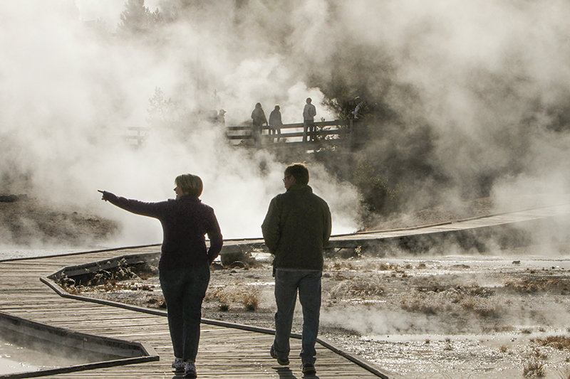 Visitors at Yellowstone National Park visit the Norris Geyser Basin, which includes Porkchop Geyser. The geyser became more active after a thermal explosion in 1989.