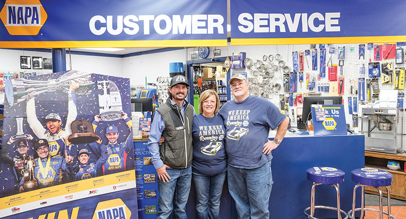 New Powell NAPA Auto Parts store owner Matthew Sweet (left) stands with cousins Jeff (right) and Leah Cooley, who owned the store for 20 years before selling it to Sweet, who took over ownership Oct. 1.