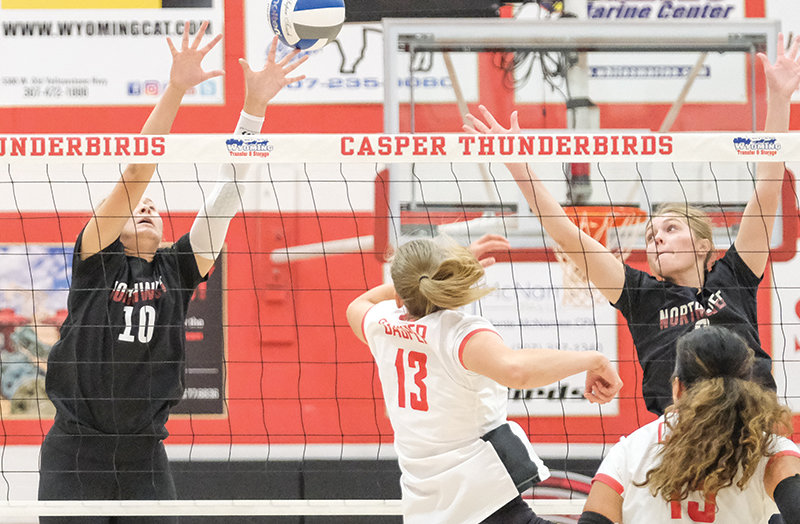 Megan Pannell (left) and Elsa Clark go up for a block against Casper College on Saturday.