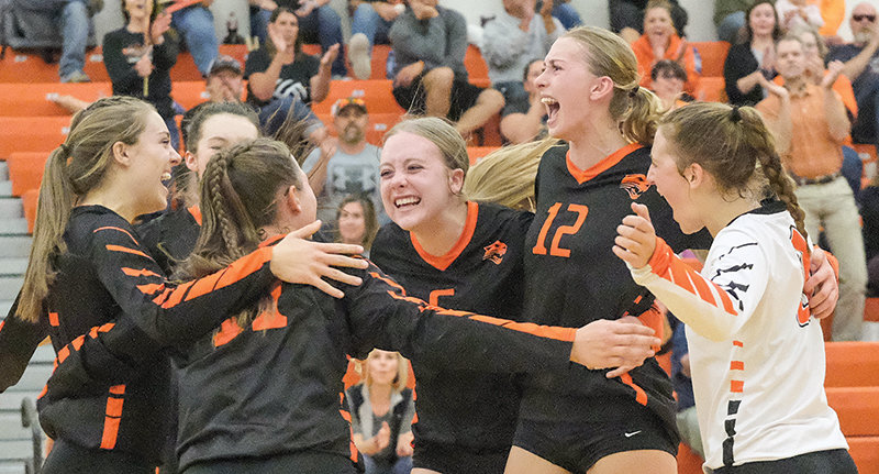 The Panther volleyball team comes together to celebrate after winning a close third set 25-23 against Cody on Tuesday.