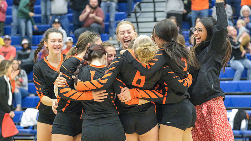 The entire Panther team storms the court after defeating Lander on Saturday in Lovell, earning the first bid to state for Powell volleyball since 2018.