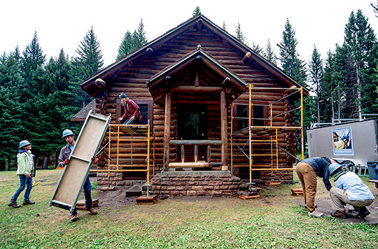 A crew of volunteers from HistoriCorps works on the old district ranger residence at the Crandall Ranger Station. The cabin was built more than 80 years ago and was in desperate need of updating as it now serves to house seasonal workers in the Shoshone National Forest. The project is being funded by the 2020 Great American Outdoors Act.